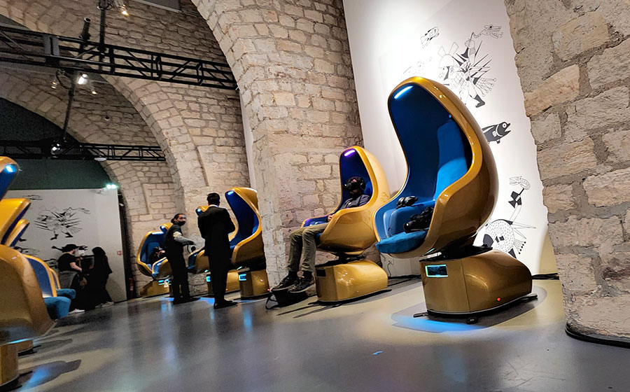 gold and blue positron chairs in room with light brick walls