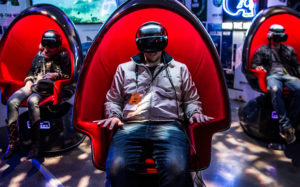 three positron chairs with people with VR goggles